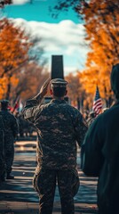 Fototapeta premium Service members saluting during a Veterans Day ceremony in a memorial park surrounded by colorful autumn trees and flags
