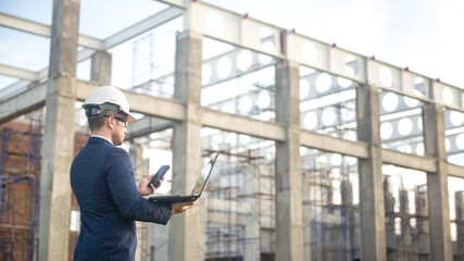an architect engineer inspecting the building construction and check the progress of the construction plan, the foreman inspecting the building construction