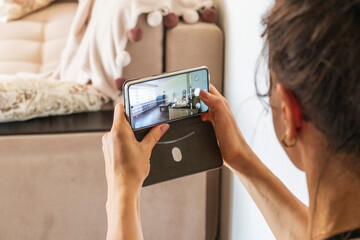 Woman taking a shot of the small room in modern apartment. Interior design