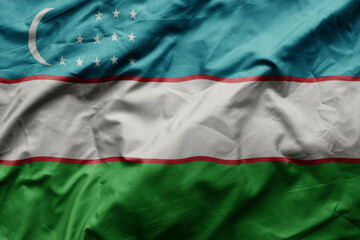 waving colorful realistic national flag of uzbekistan .