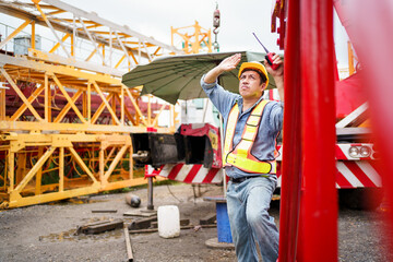 Careless worker at construction site without wearing helmet.