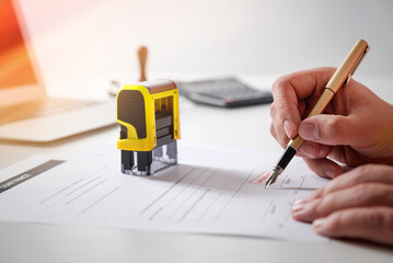 Businessman signing a contract on desk