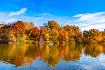 Park boat in autumn pond, New York. Scenic fall. Central park in autumn. Autumn landscape. Boat in pond. Fall nature landscape. Autumn nature in Central park. Seasonal fall landscape. Boating season