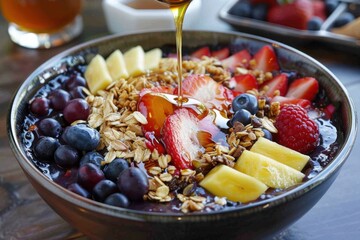 A vibrant acai bowl with fresh fruit, granola, and a drizzle of honey 