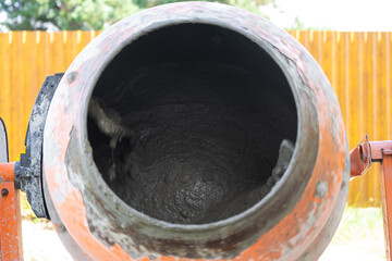 Mixing mortar in a handheld portable concrete mixer