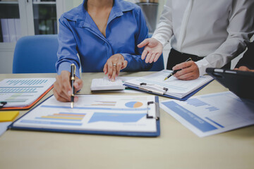 Investors review business performance metrics, analyze potential returns, and engage in discussions. They shake hands and finalize agreements to secure investments, aiming to capitalize