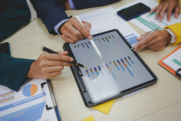 Investors review business performance metrics, analyze potential returns, and engage in discussions. They shake hands and finalize agreements to secure investments, aiming to capitalize