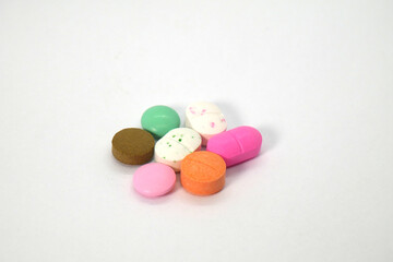 close up of colorful medicine tablets on the white background isolated