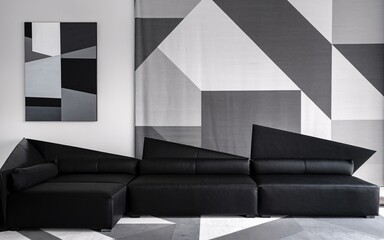 Modern Living Room with Black Sectional Sofa and Geometric Rug
