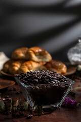 Butter croissants on a wooden plate with ingredients for breakfast or a snack and coffee beans 