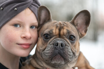 Portrait of a beautiful ten year old girl with a dog.