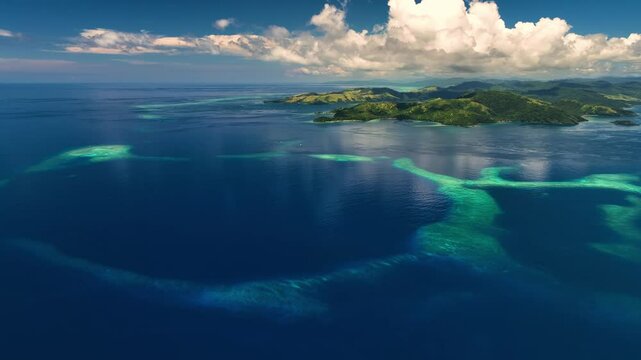 Aerial view of a beautiful Fiji with coral reef and clouds, uninhabited location.