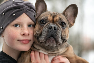 Portrait of a beautiful ten year old girl with a dog.