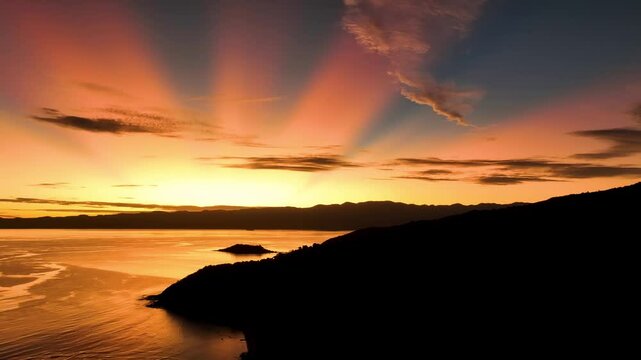 Aerial view of serene sunrise over tranquil ocean and picturesque coastline, Fiji.