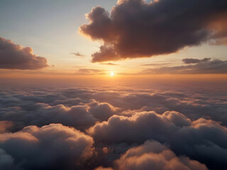 The sun is setting over the clouds in the sky