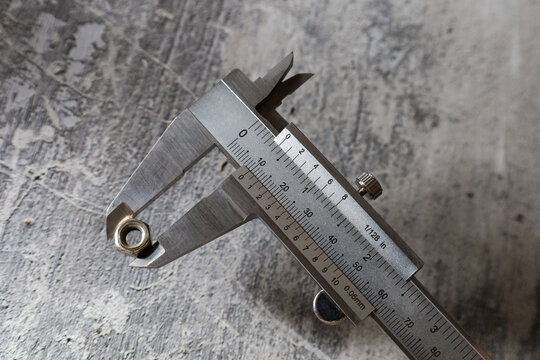 Measuring the size of a nut using a vernier caliper