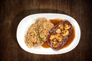 Steak a Diana with risotto on the plate seen from above