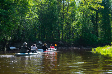 Group kayak trip for seigneur and senora . An elderly couple And adult rowing boat on the river, a water hike, a summer adventure. Age-related sports, mental youth and health, tourism, active old age