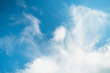 Fototapeta premium bright summer day with cumulus clouds scattered across a vivid blue sky, creating a serene and abstract backdrop that captures the essence of nature beauty and the peaceful environment around.