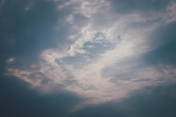 Fototapeta premium The sky is cloudy and the sun is barely visible. The clouds are dark and the sky is mostly grey