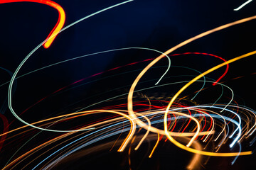 The image is a colorful swirl of lights that creates a sense of movement and energy. The bright colors and dynamic lines give the impression of a fast-paced, exciting scene