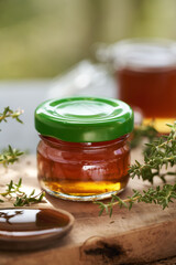 A jar of thyme syrup on a table