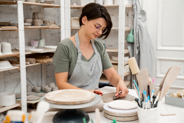 Creating perfect homogenous consistence for ceramics handcraft. Wedging the clay to eliminate air...