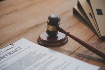 Judge gavel with Justice lawyers having team meeting at law firm background. Concepts of Law and Legal services.