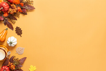 Bright autumn greeting card mock up with candles, pumpkins and decorations on light orange...