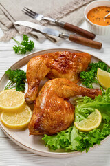fried chicken legs with lettuce, lemon on plate