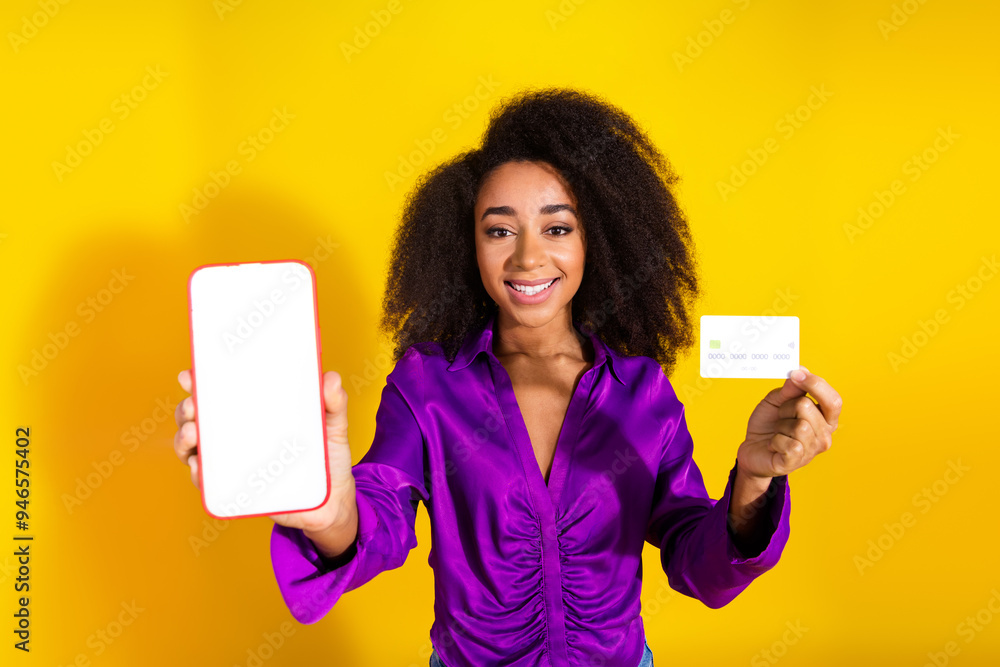 Poster Photo portrait of pretty young girl hold credit card white screen device wear trendy violet outfit isolated on yellow color background