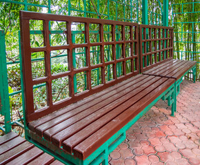 Long wooden bench with carved lattice as a backrest