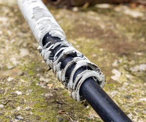 Gray cable conduit that has deteriorated over time