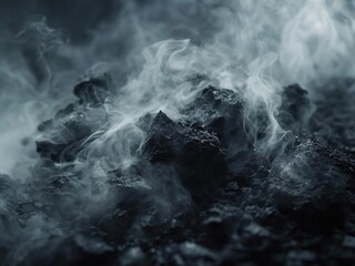 Close-up of swirling smoke rising from a bed of dark, charcoal embers, creating a moody and atmospheric scene.