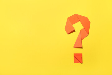 Question mark made of paper on yellow background