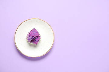 Plate of panna cotta with beautiful hydrangea flowers on lilac background