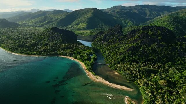 Aerial view of tropical reef at sunrise with beautiful beach and mountains, New Caledonia, New Caledonia.