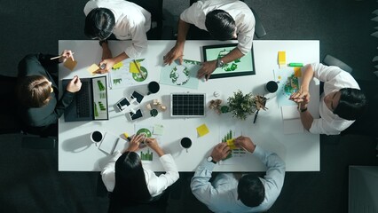 Top down view of business team discussing about using clean energy and sustainable investment at...