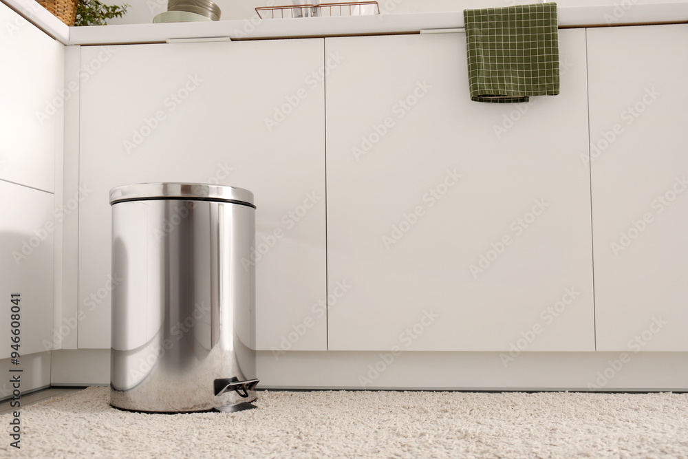 Sticker metallic trash bin in interior of modern kitchen