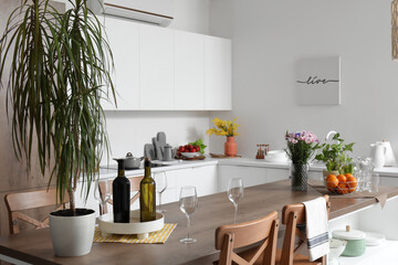 Interior of light kitchen with stylish island table