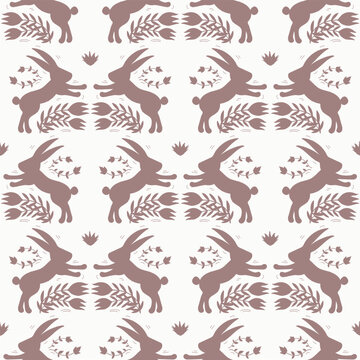 Vintage rabbit pattern in muted dusty pink on an off-white background. Symmetrical animal silhouette and floral motifs design in a folk art style. Festive vibe is great for Easter and Christmas.