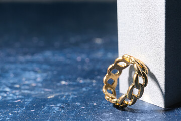 Decorative podium with golden ring on grunge blue background