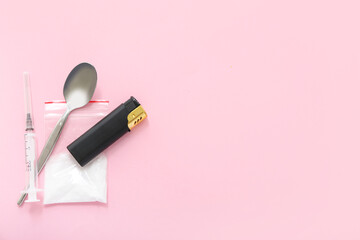 Drugs, spoon, lighter and syringe on pink background