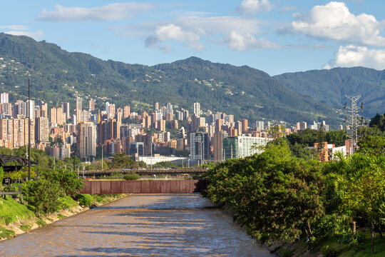 panorama of Medell&iacute;n, Medellin, Antioquia, Colombia. View from the Parques del R&iacute;o Medell&iacute;n, translatable into English as Parks of the Medell&iacute;n River. Blue sky. Buildings. Andes mountains.