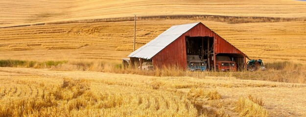 A red barn in the fall season in the palouse wheat country in southeastern Washington. © Bob