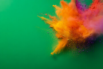 Colorful powder explosion on green background