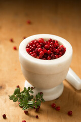 A mortar full of ripe wild lingonberries