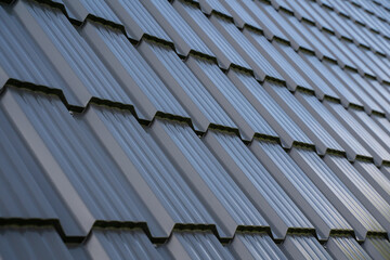 Presenting a detailed closeup view of modern roof tiles that showcase a sleek and shiny metallic finish