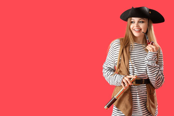 Beautiful female pirate with spyglass on red background