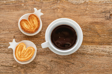 Cup of coffee, heart shaped cookies for Jewish holiday Rosh Hashanah over wooden background. Top view.